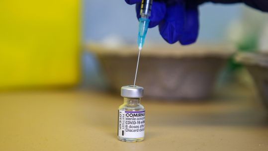 Anonymous hand prepares to give coronavirus COVID booster vaccine jab (Picture: Zuma Press Alamy).