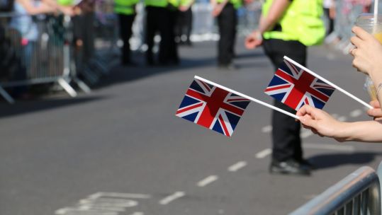 Anonymous hands holding Union flags British flags at Armed Forces Day 290619 CREDIT BFBS.jpg