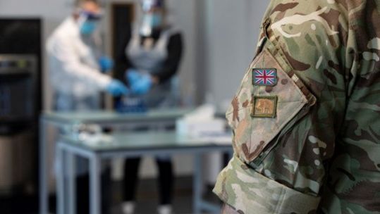 Anonymous member of the Armed Forces, from RAF Wittering, supervising completed coronavirus tests at Bourne Grammar School 120121 CREDIT MOD