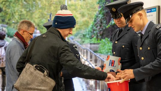 Armed Forces personnel selling poppies as part of London Poppy Appeal