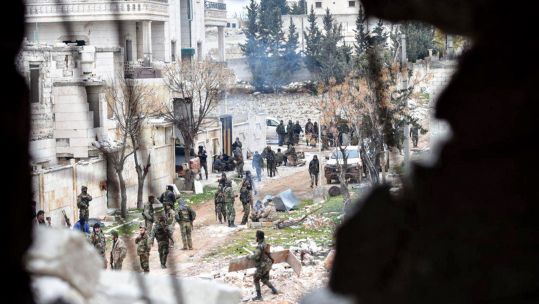 Armed soldiers of the Syrian government paroling after taking control of the Rashideen district near the Aleppo-Damascus highway