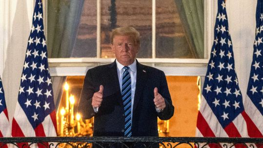 Cover image: Mr Trump gives a double thumbs-up after arriving back at the White House (Picture: PA).