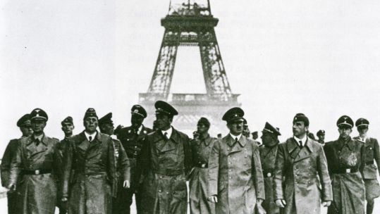 Adolf Hitler beneath the Eiffel Tower. Credit: Alamy