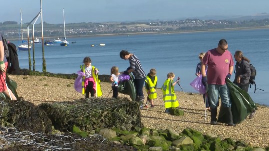 Volunteers cleaning up rubbish from Langstone Harbour beach