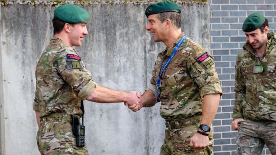 Bear Grylls visited HM Naval Base Clyde and presented his award of Unsung Hero to a Royal Marine (Picture: Royal Navy)