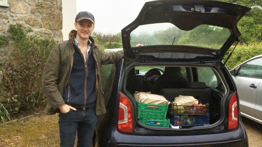 Cover image: Ben Baily with provisions he's delivering (Picture: Royal Navy).