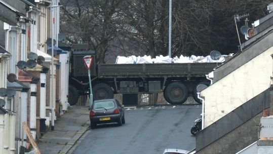 Bomb disposal experts remove a ordnance on the back of a vehicle near to the scene at St Michael Avenue, Plymouth, where residents have been evacuated and a cordon put in place following the discovery of the suspected explosive device (Picture: PA).