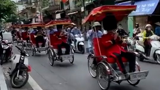 Brass quintet of the Band of the Royal Regiment of Fusiliers perform song on rickshaws through Hanoi 080923 CREDIT 5 FUSILIERS