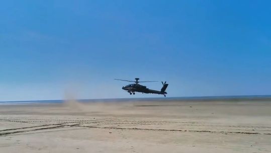 British Army Apache lands on Army's training area at Pembrey Sands