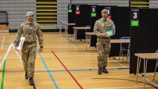 Cover image: Soldiers set up a vaccine centre in Scotland (Picture: MOD).