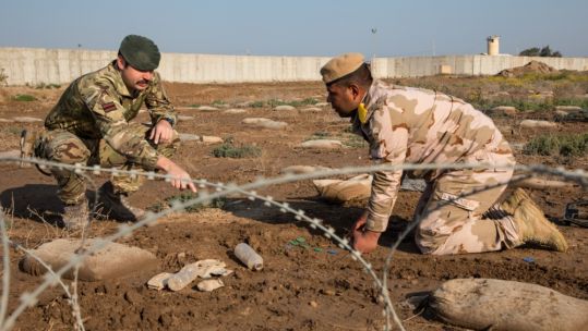 British Army trainer teaches Iraqi soldier in counter-IED training at Camp Taji