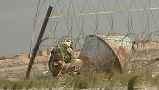 British soldier attends to the scene of an IED in Iraq.