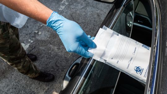 COVID19 Coronavirus test kit is posted through the car window at the Mobile Testing Unit in Kendal 250420 CREDIT MOD.jpg