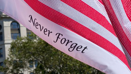 Remembrance flag with names of those who lost their lives in 9/11 terrorist attacks, Battery park, New York, USA (Picture: Francisco Martinez / Alamy).