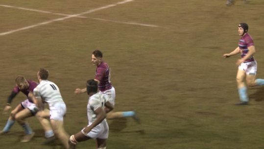 Cambridge University rugby union player tackled by RAF player.