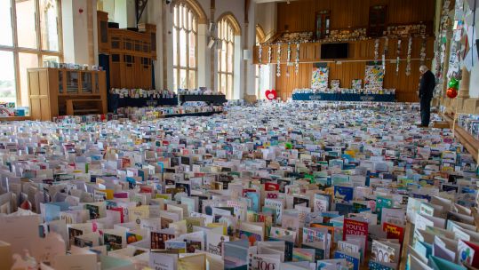 Cover image: Some of the 150,000 birthday cards sent to Captain Tom ahead of his birthday earlier this year (Picture: MOD).