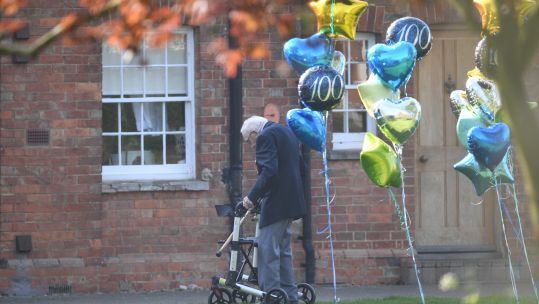 Captain Tom Moore with balloons outside his Bedfordshire home (Picture: PA).