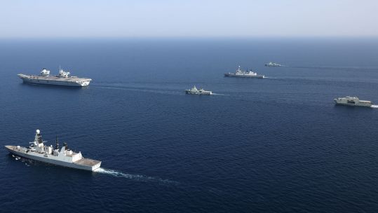 From left to right, front to back is HMS Queen Elizabeth, RNOV Shinas, HMS Defender, RNOV Sadh, HMS Diamond, RNOV Seeb and RNOV Al Mubshir (Picture: Crown Copyright).