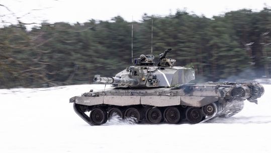 Challenger 2 Main Battle Tank from The Queens Royal Hussars moves across the snow
