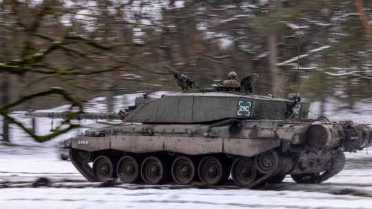 Challenger 2 Main Battle Tank from The Queens Royal Hussars moves across the snow during a combined arms manoeuvre on Sennerlager Training Area 23012023 CREDIT MOD Crown Copyright