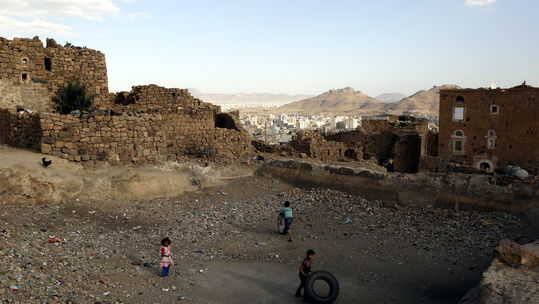 Chidren play near a house in Sanaa, Yemen