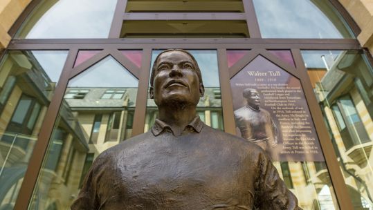 Close up of the footballer Walter Tull from a statue at the Guildhall, Northampton, UK