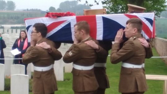 The coffin is carried to the burial site (Picture: Crown Copyright).