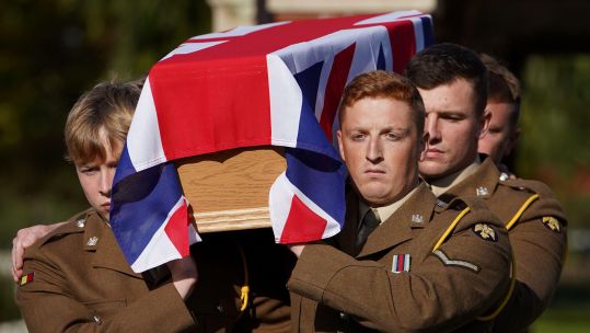 Coffin of Lance Corporal Robert Cook, who died in WW1, is carried in to the Commonwealth War Graves Commission's (CWGC) New Irish Farm Cemetery near Ypres in Belgium