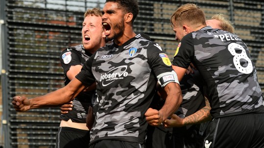 Colchester United players celebrate a last-gasp equaliser against Mansfield Town in their camo away kit (Picture: Colchester United).