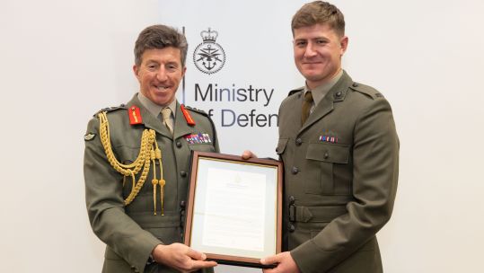 Commandant General of the Royal Marines awarding the Royal Marine of the Year award to Corporal Jack Crawford