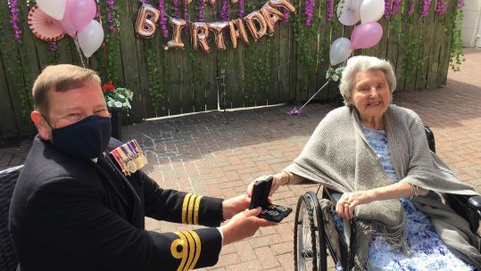 Commander Andy Swain presents Former Navy Wren Jacqueline with her WWII medals on her 100th birthday 16062021 CREDIT ROYAL NAVY