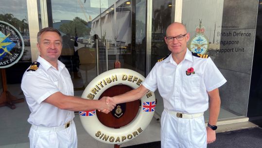 Cover image: Commander Paul Bastiaens (left) hands over command in Singapore to Commander Tim Hutchins (Picture: Royal Navy).