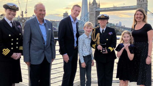 Commodore Jo Adey pictured with the Botting-Townsend family, including Edward and Alice at the medal ceremony (Picture: Royal Navy).