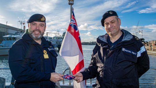 Cover image: Commodore Tim Neild presenting the LSA5K award to LS John Gibson on board HMS Magpie (Picture: Royal Navy).