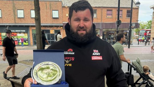 Corporal Rhys Calland of British Army with 3rd place trophy for Ultimate Strongman