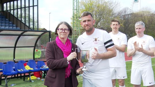 Craig Thomson receives trophy on behalf of the Army Reserves with Commander of the Maritime Reserves Commodore Jo Adey CREDIT BFBS DATE 13042025.jpg