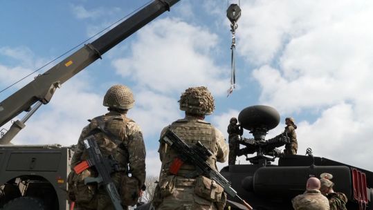 A crane is brought in to lift off the target-acquisition radar