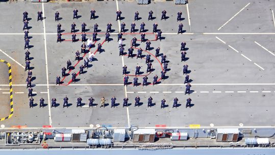 Cover image: Crew on board RFA Argus spell out '75' for VE Day (Picture: Royal Navy).