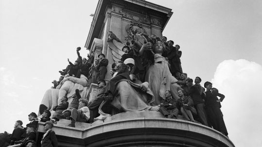 Cover image: People celebrate VJ Day in 1945 on Victoria Memorial outside Buckingham Palace (Picture: EMPICS Archive/PA).