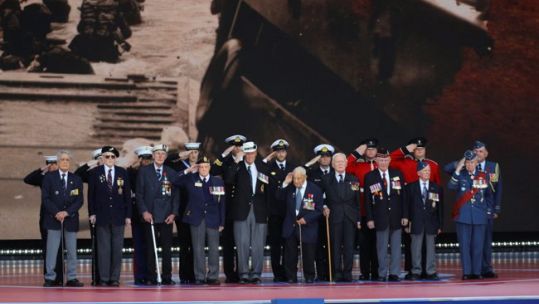 D-Day veterans join armed forces personnel on stage at the D-Day 75 
