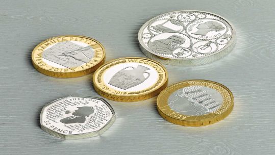 D-Day commemorative coin is pictured on the bottom right (Picture: The Royal Mint/PA).