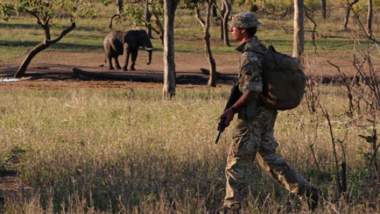 British soldier on patrol with park rangers in Malawi