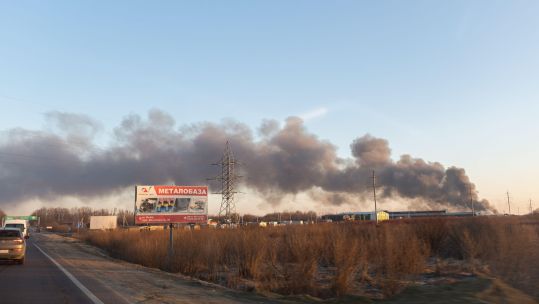 Dark smoke is seen on the horizon after a Russian missile strike hit the airport in Lviv, Ukraine 
