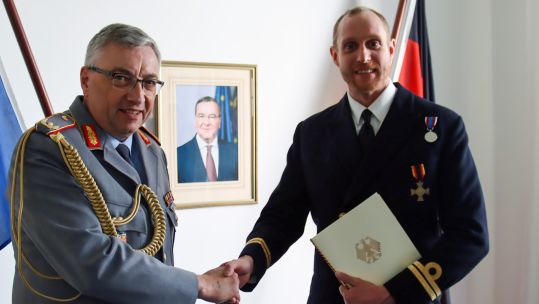 Defence Attach Brigadier General Michael Oberneyer presenting Lieutenant Edmund Read with his Ehrenkreuz medal (Picture: Royal Navy).