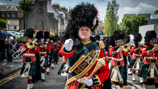 Drum Major Medhurst-Feeney leads the Band of the Royal Regiment of Scotland at the Riding of the Marches