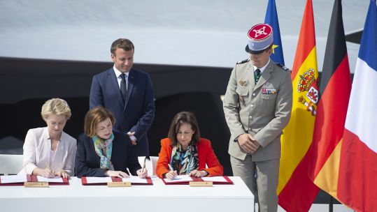 Emmanuel Macron with Ursula von der Leyen, Florence Parly and Margarita Robles sign a deal at Paris Air Show 170619 CREDIT PA