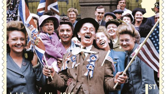 Cover image: Crowds celebrate VE Day in 1945 (Picture: Royal Mail).