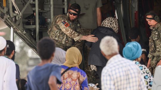 Evacuees helped onboard RAF C-130 aircraft Wadi Seidna airport Sudan 270423 CREDIT MOD 