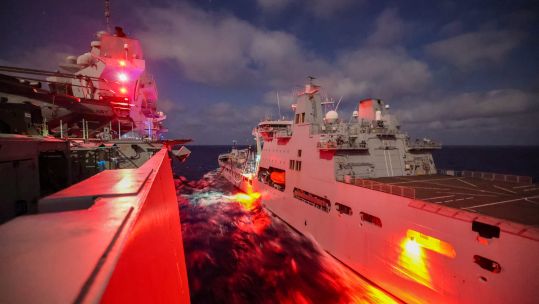 HMS Queen Elizabeth conducts a night Replenishment At Sea with RFA Tidespring. Picture: UK MOD / Crown Copyright.
