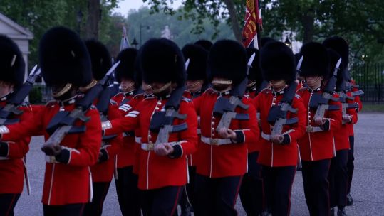 Guardsmen return to Wellington Barracks after the pre-dawn rehearsal
